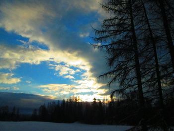 Snow covered landscape at sunset