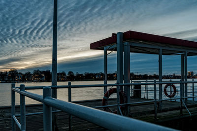 Bridge over river against sky during sunset