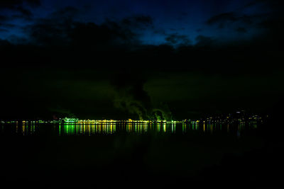 Reflection of illuminated lights in lake at night