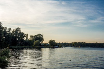 Scenic view of river and trees against sky