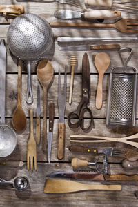 Various kitchen utensils hanging on wood