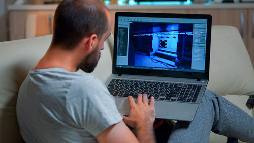 Man using laptop at home