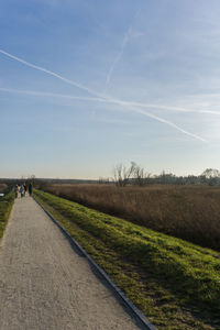 Road by landscape against sky