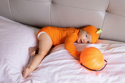 High angle view of boy sleeping on bed at home