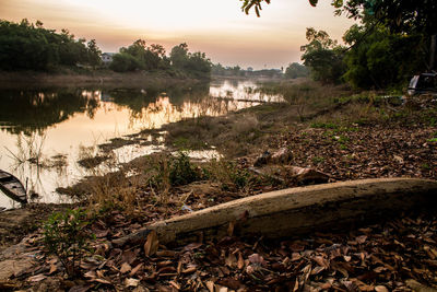Scenic view of lake against sky at sunset