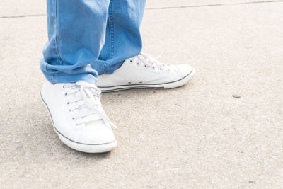 Low section of man standing on footpath