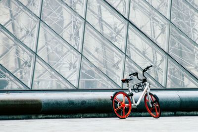 Bicycle parked on wall of building