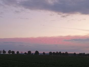 Scenic view of field against sky during sunset