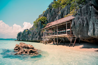 Wooden cottage at the white sand shore at limestone island of coron, palawan, philippines.