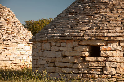 Stone wall against clear sky