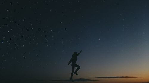 Silhouette of woman standing at night