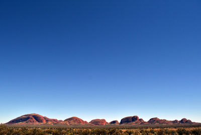 Scenic view of rock mountains against clear blue sky