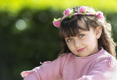 Portrait of woman with pink flower