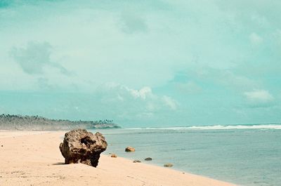 Scenic view of sea against cloudy sky