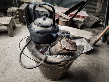 Close-up of container on wood burning stove