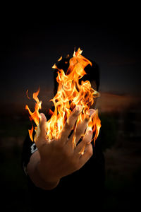 Close-up of bonfire on wood at night