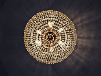 Directly below shot of illuminated chandelier hanging from ceiling