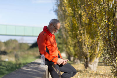 Rear view of man walking on footpath