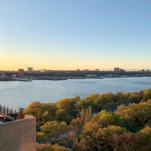 Scenic view of river by buildings against clear sky