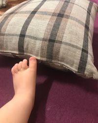 Low section of child legs on bed