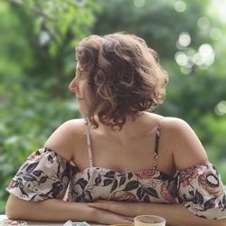 Rear view of woman sitting outdoors