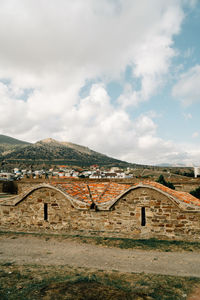 View of old building against cloudy sky