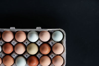 Directly above shot of eggs in container on table