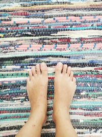 Low section of child standing on carpet