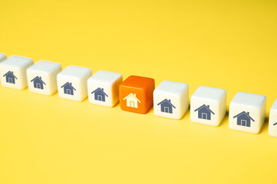 Close-up of toy blocks on yellow background