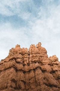 Low angle view of rock formation against sky