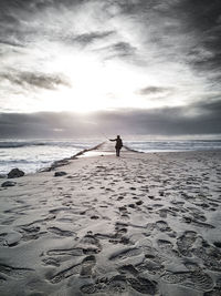 Man on beach against sky