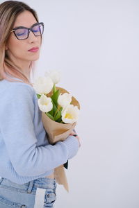 High angle view of young woman holding bouquet