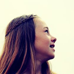 Close-up portrait of a young woman against white background