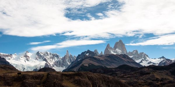 Scenic view of mountains against cloudy sky
