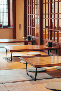 Empty chairs and table in room