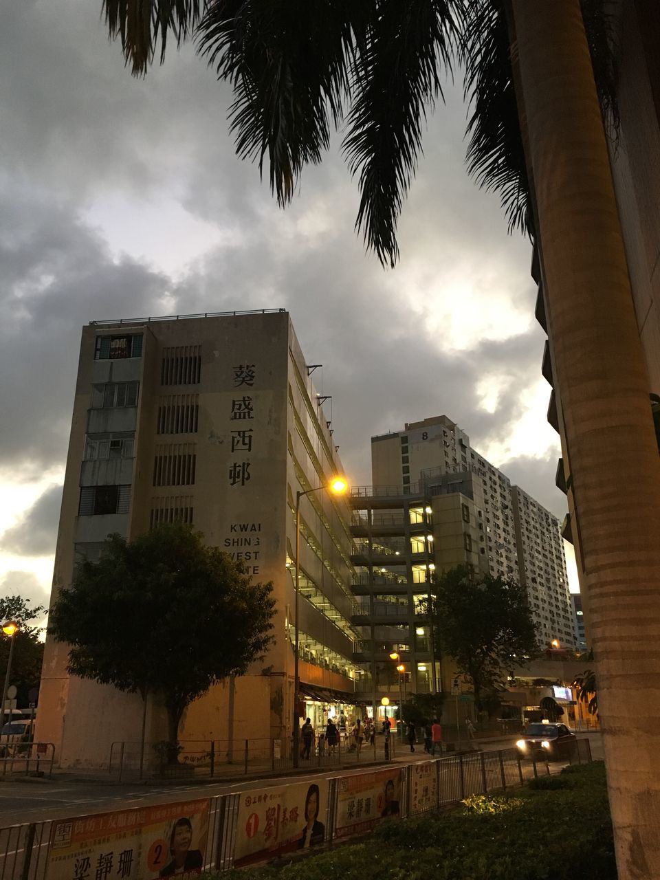 architecture, built structure, building exterior, sky, cloud - sky, reflection, city, cloudy, tree, transportation, water, illuminated, low angle view, bridge - man made structure, dusk, weather, cloud, street light, outdoors, building