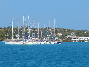 Boats in sea against clear sky