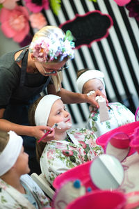 Tilt shot of beautician with girls at spa