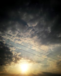 Low angle view of silhouette birds flying against sky during sunset