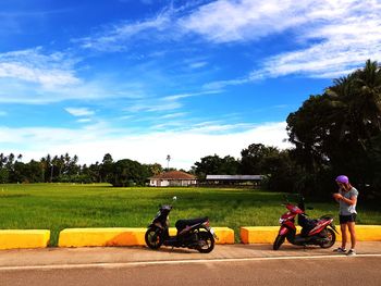 Bicycles parked on road against sky