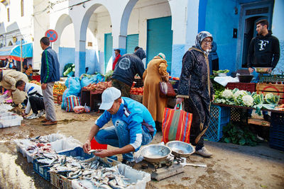 Group of people sitting in market