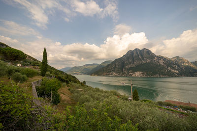 Scenic view of sea and mountains against sky