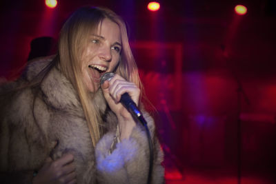 Young woman singing karaoke