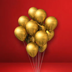Close-up of multi colored balloons against red background