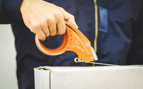 Midsection of man working in factory