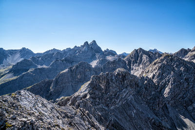 Scenic view of mountains against clear blue sky