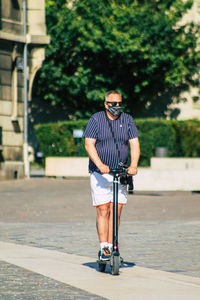 Man with umbrella standing on road