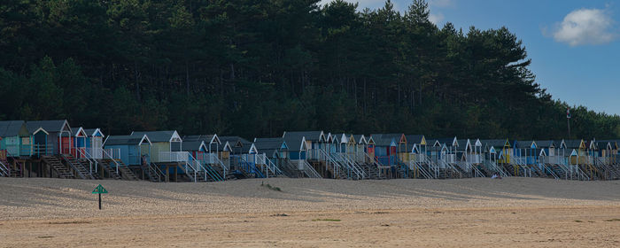 Chairs on beach against sky