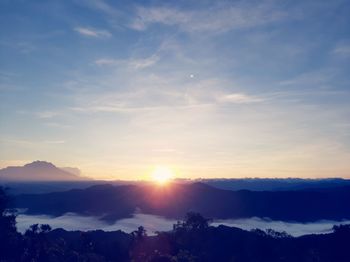 Scenic view of silhouette mountains against sky at sunset