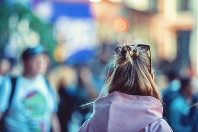 Rear view of woman standing in city